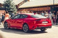 Moscow / Russia Ã¢â¬â 08 31 2018: Red car Kia Stinger with showgirl on automotive Royalty Free Stock Photo